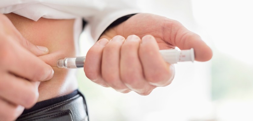A person with diabetes using an insulin injection to manage blood sugar levels