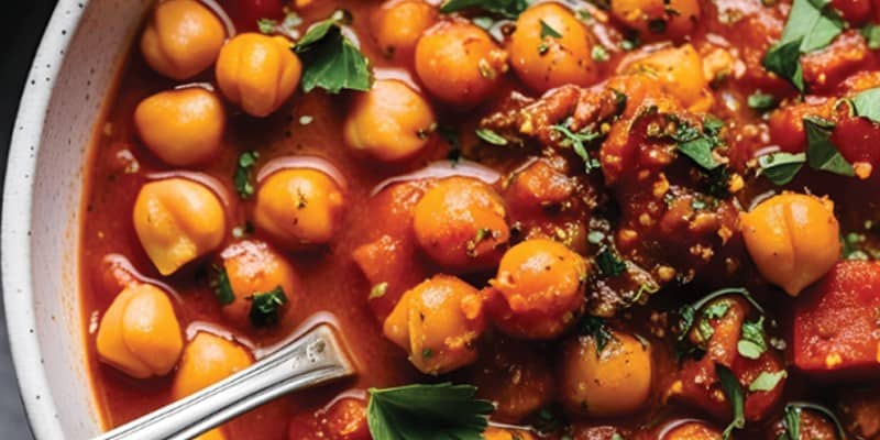 A bowl of chickpea stew with tomatoes, combining iron and vitamin C for better nutrient absorption